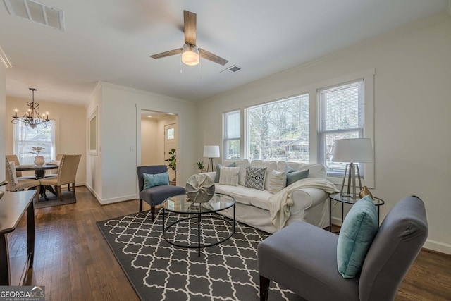 living room with visible vents, dark wood-type flooring, and a healthy amount of sunlight