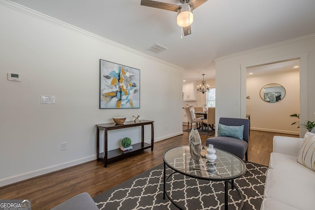 living room featuring baseboards, ornamental molding, and dark wood finished floors