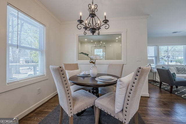 dining space featuring wood finished floors, baseboards, and ornamental molding