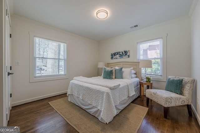 bedroom with visible vents, baseboards, dark wood-type flooring, and crown molding