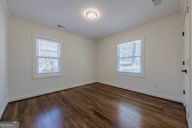 unfurnished room featuring visible vents, baseboards, dark wood finished floors, and ornamental molding