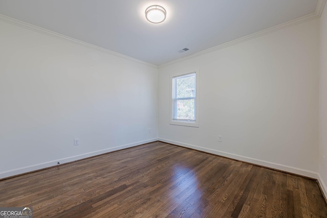 unfurnished room with baseboards, dark wood-style floors, visible vents, and ornamental molding