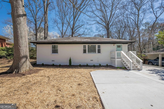 ranch-style home with crawl space, a shingled roof, and brick siding