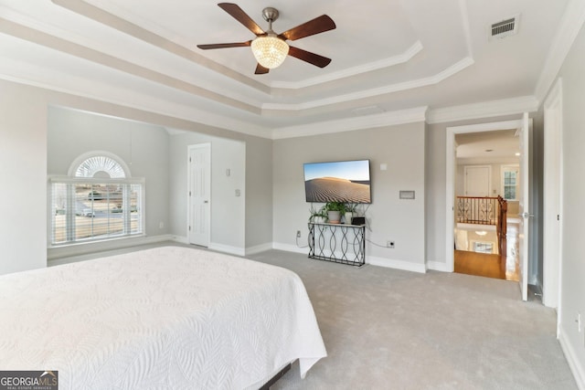 carpeted bedroom featuring a ceiling fan, visible vents, baseboards, a raised ceiling, and crown molding