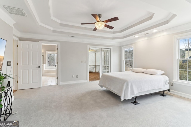 bedroom featuring a tray ceiling, carpet flooring, visible vents, and crown molding