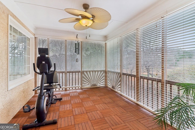 unfurnished sunroom featuring ceiling fan