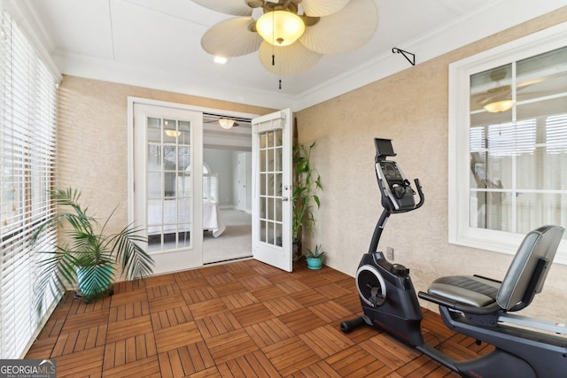 exercise room with french doors and a ceiling fan