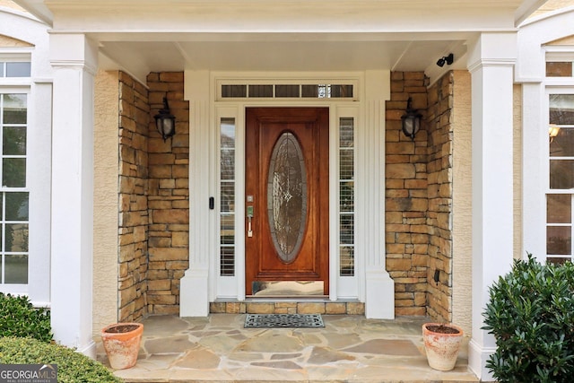 property entrance featuring stone siding