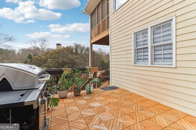 view of patio with a grill and a balcony