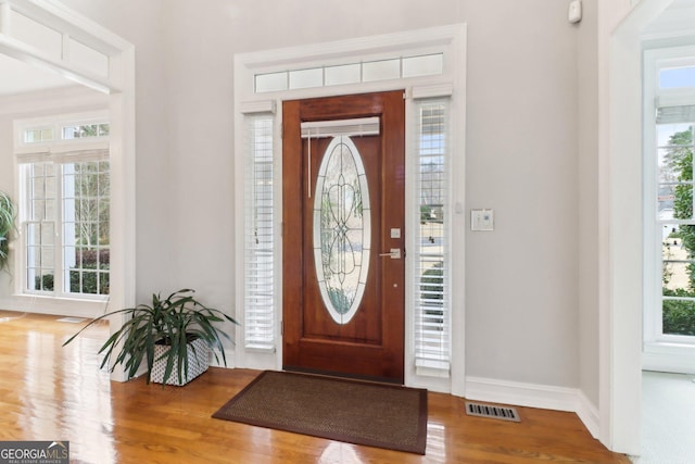 entryway featuring a healthy amount of sunlight, visible vents, and wood finished floors