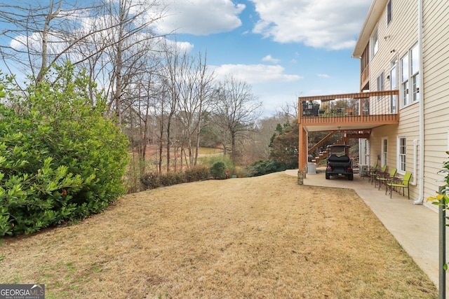 view of yard featuring stairway, a patio area, and a deck