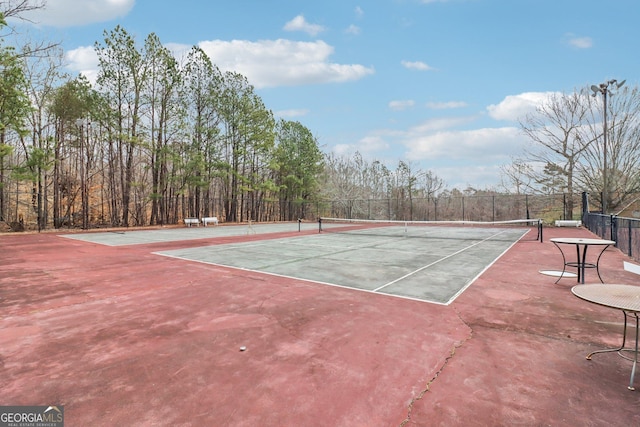 view of tennis court featuring fence