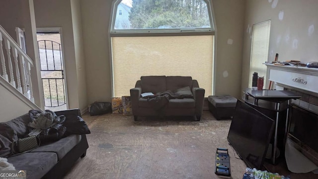 living room featuring stairway and a healthy amount of sunlight