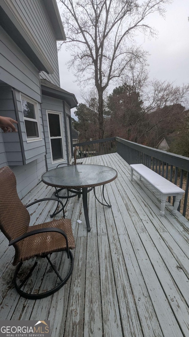 wooden deck featuring outdoor dining area