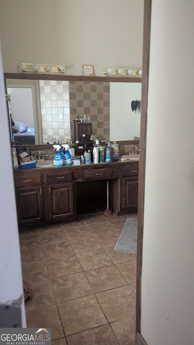 bathroom with double vanity, tile patterned flooring, and a sink