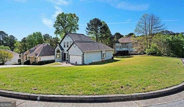 exterior space featuring a garage and a lawn