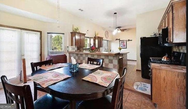 tiled dining area with visible vents and ceiling fan