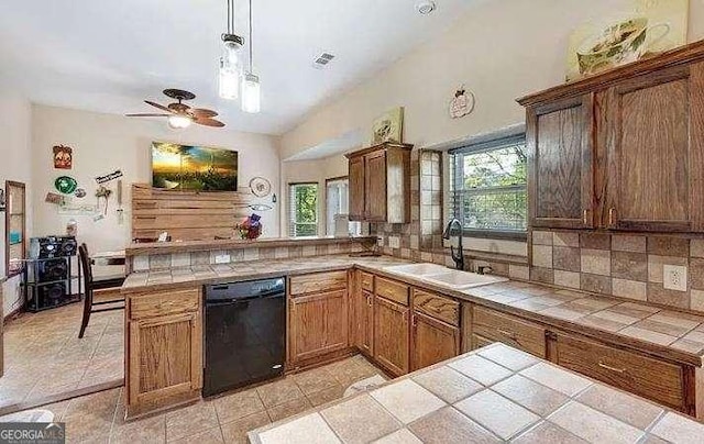 kitchen featuring tile countertops, a sink, backsplash, and dishwasher