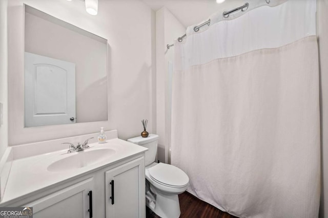 bathroom featuring a shower with curtain, vanity, toilet, and wood finished floors