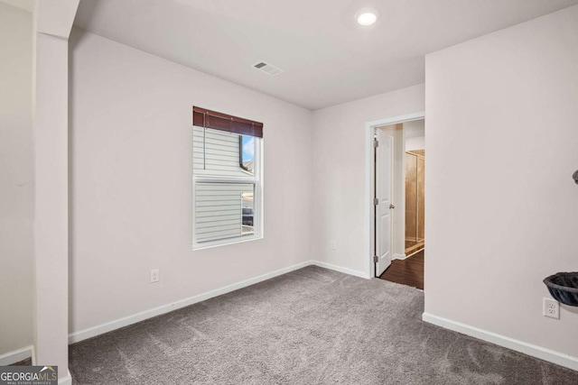 carpeted empty room with recessed lighting, visible vents, and baseboards