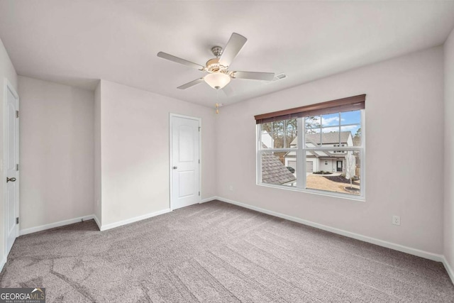 unfurnished bedroom with ceiling fan, baseboards, and carpet flooring