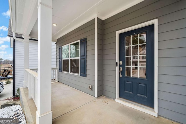 view of exterior entry with a porch