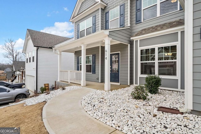 view of front of house featuring a shingled roof and a porch