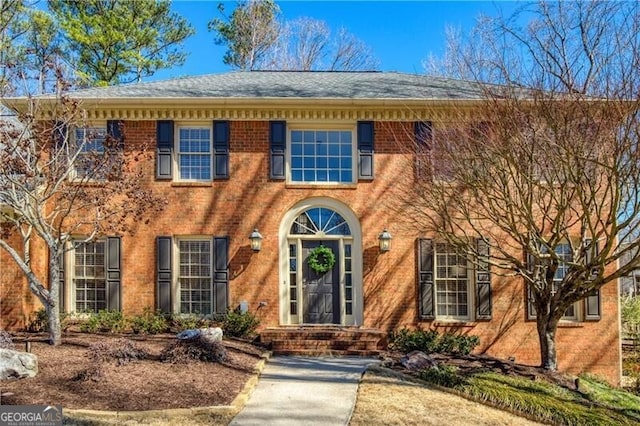 colonial house featuring brick siding