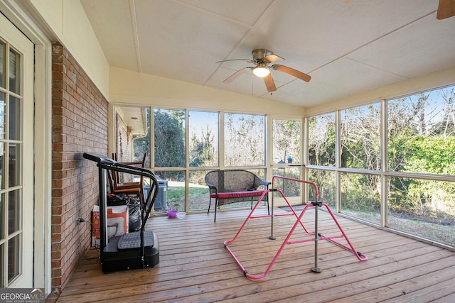 unfurnished sunroom featuring lofted ceiling and ceiling fan