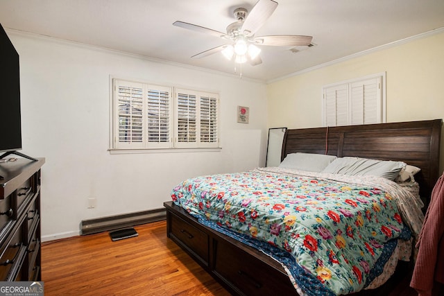 bedroom with baseboard heating, a ceiling fan, light wood-style floors, and ornamental molding