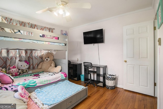 bedroom featuring a ceiling fan, wood finished floors, and ornamental molding