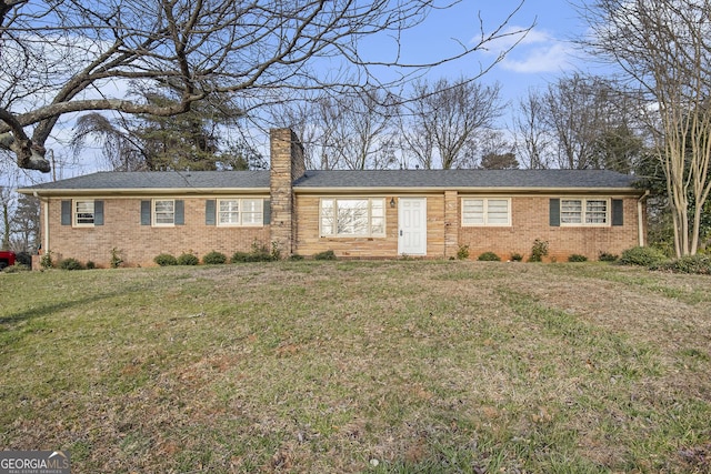 single story home featuring a front yard, brick siding, and a chimney