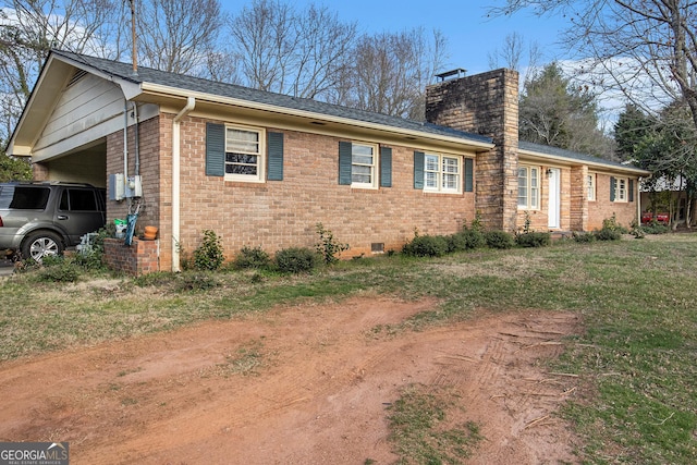 view of home's exterior featuring crawl space, brick siding, a garage, and a chimney