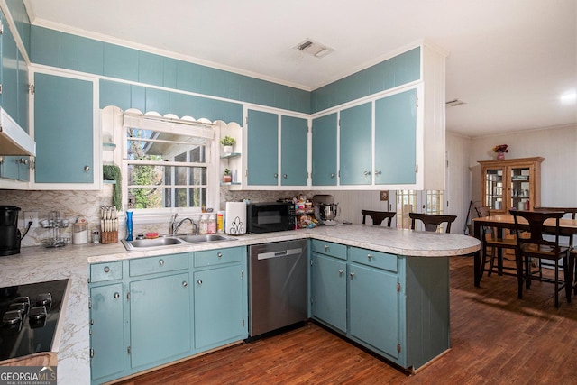 kitchen featuring visible vents, ornamental molding, a peninsula, black appliances, and a sink