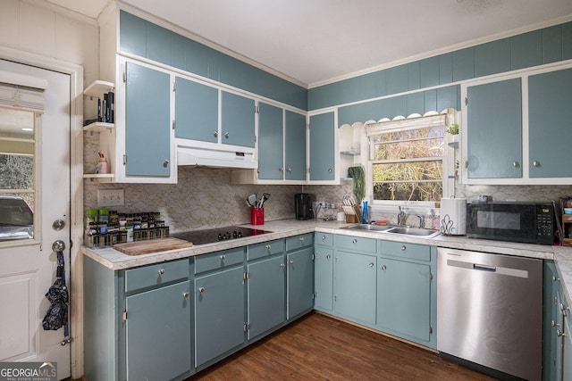 kitchen featuring under cabinet range hood, ornamental molding, decorative backsplash, black appliances, and a sink