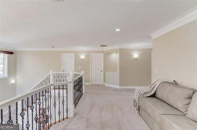 corridor featuring crown molding, an upstairs landing, baseboards, and light carpet