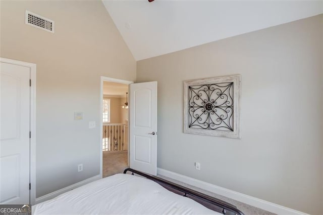 bedroom featuring visible vents, baseboards, high vaulted ceiling, and carpet flooring