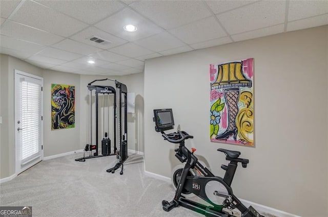 workout room with carpet flooring, baseboards, visible vents, and a paneled ceiling