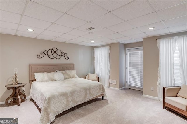 carpeted bedroom featuring recessed lighting, baseboards, visible vents, and a drop ceiling