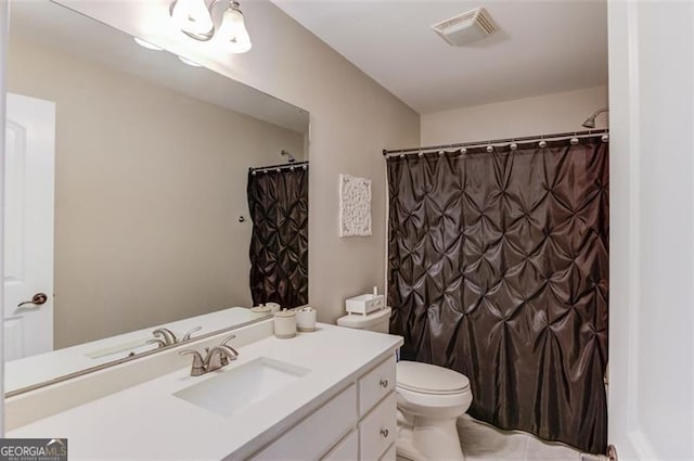 full bathroom featuring vanity, toilet, and visible vents