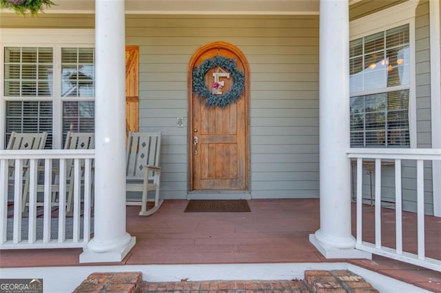 view of exterior entry featuring a porch