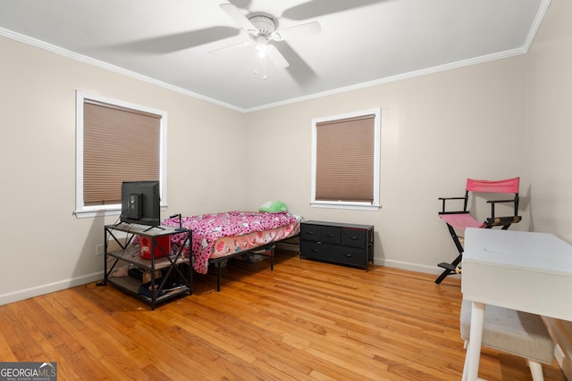 bedroom with baseboards, wood finished floors, and crown molding