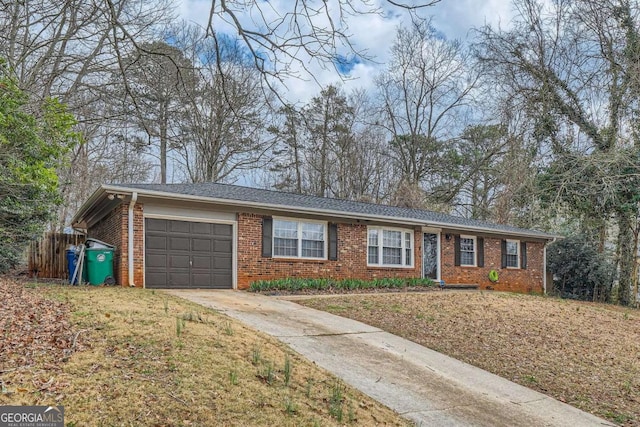 ranch-style home with driveway, an attached garage, fence, a front lawn, and brick siding