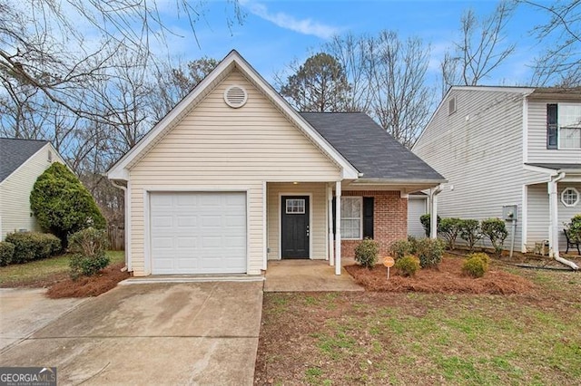 view of front of property featuring a garage, covered porch, brick siding, driveway, and roof with shingles