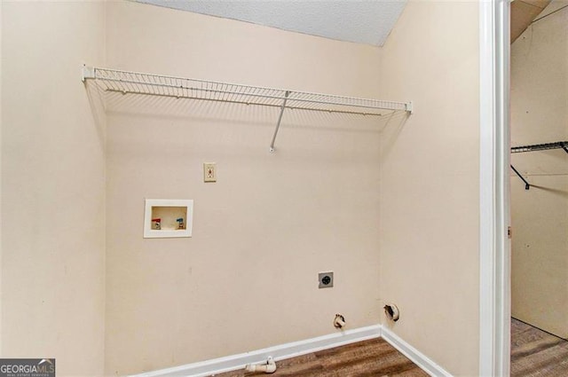 laundry area featuring laundry area, baseboards, wood finished floors, hookup for a washing machine, and electric dryer hookup