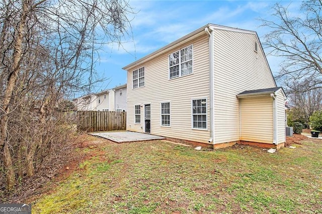 rear view of house featuring a yard, fence, and a patio