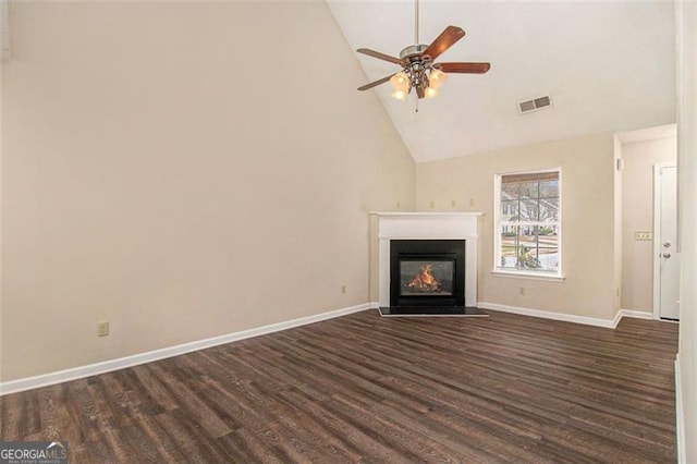 unfurnished living room featuring a fireplace with flush hearth, a ceiling fan, visible vents, baseboards, and dark wood finished floors