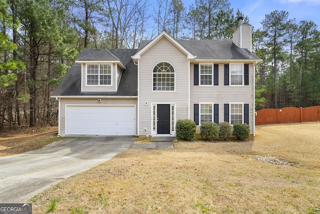 view of front of house featuring a garage, fence, concrete driveway, a chimney, and a front yard