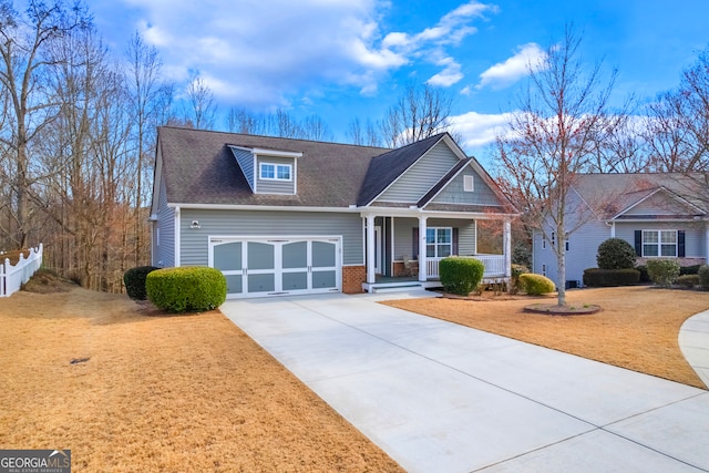 view of front of home with a porch, a garage, brick siding, driveway, and a front lawn