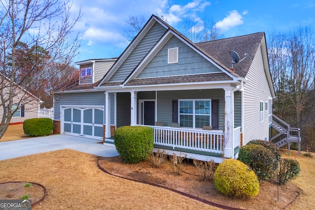 view of front of home featuring a garage, covered porch, roof with shingles, and driveway